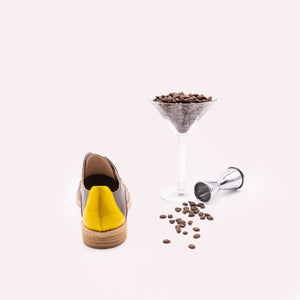 Yellow heel detail of brown oxfords