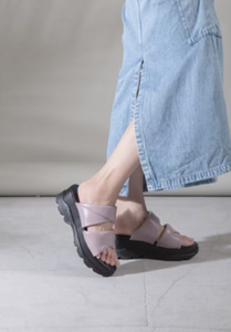 Purple slide sandals worn with denim midi skirt