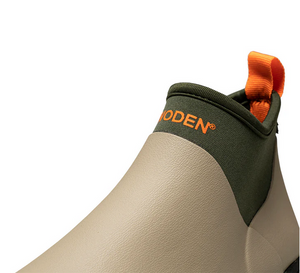 Light green waterproof boot with khaki and orange details close up