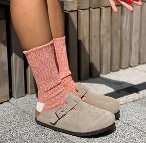 woman wearing orange cotton socks with tan clogs
