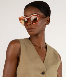 woman wearing orange sunglasses looking to side