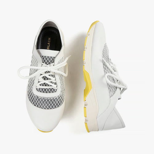 White mesh sneakers with yellow trim sole