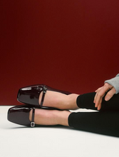 Load image into Gallery viewer, Burgundy patent classic Mary Jane shoes worn with black leggings