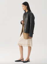 Load image into Gallery viewer, woman wearing leather jacket and white dress with black slingbacks