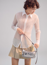 Load image into Gallery viewer, Model wearing white shirt &amp; tan mini skirt carrying silver bag