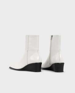 back view of white leather boot with black wedge heel