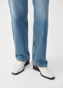 White wedge boots worn with jeans