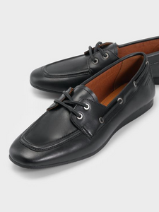 close up of black leather boat shoe flats with leather laces