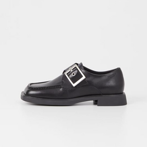 Black shoe with oversized silver buckle