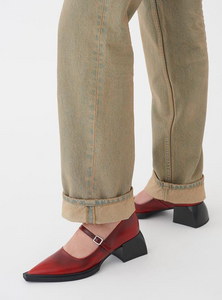 Red Mary Jane shoes worn with distressed jeans