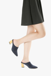 Navy suede mules worn with black dress