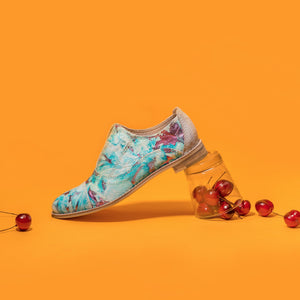 Turquoise and pink metallic pony hair slip-on flat oxfords.