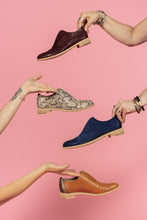 Load image into Gallery viewer, Models holding Tan snakeskin, Cognac Tan, Navy, and Oxblood leather oxfords