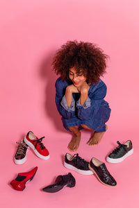 Model surrounded by colorful BUS STOP X shoes