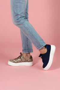 Model wearing Tan snakeskin chunky sneaker and Navy nubuck and embossed leather chunky sneaker