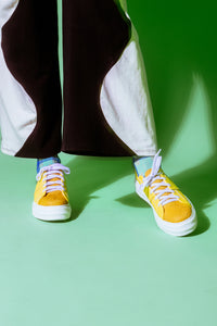 Yellow Sneakers worn with black and white pants