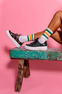 Model wearing Black and Gold patterned chunky sneaker and Dark Green embossed snakeskin leather chunky sneaker