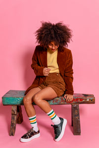 Model wearing Black and Gold patterned chunky sneaker and Dark Green embossed snakeskin leather chunky sneaker