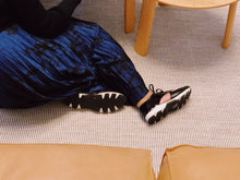 Load image into Gallery viewer, Model wearing Black leather &amp; black patent lace-up urban sneaker.