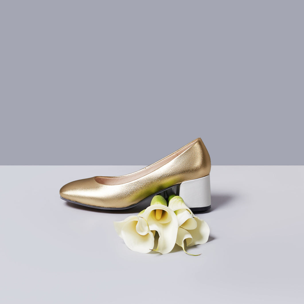Gold metallic leather upper pump with 3-inch white heel.