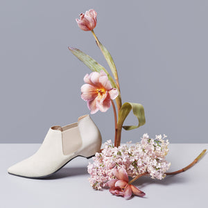 Off-White pony-hair bootie with off-white patent leather heel.