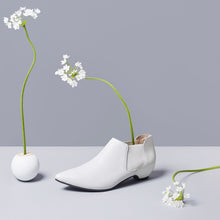Load image into Gallery viewer, White leather slip-on bootie with white patent leather heels.