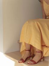 Load image into Gallery viewer, Red strappy sandal worn with yellow dress