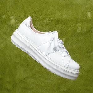 White leather lace-up sneaker with a light chunky white sole.