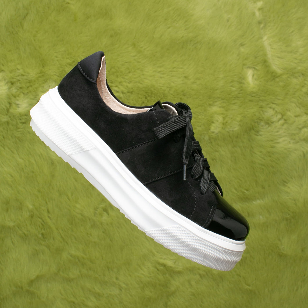 Black suede and patent leather sneakers.