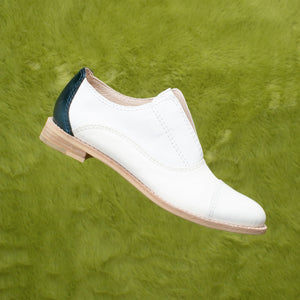 White leather slip-on flat with a dark blue metallic heel oxford.