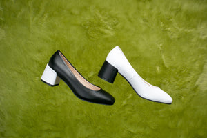Black and white leather pump with chunky heels.