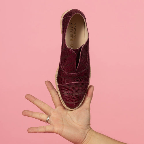 Model holding Oxblood wine leather embossed oxford