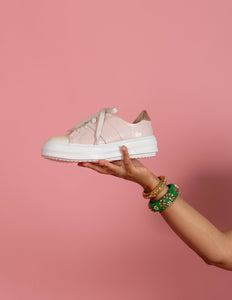 Model holding Pink and Cream chunky sneaker