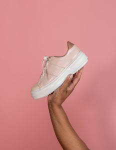 Model holding Pink and Cream chunky sneaker