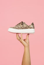 Load image into Gallery viewer, Tan snakeskin chunky sneaker held by model