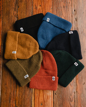 Load image into Gallery viewer, multi colored beanies on wood background