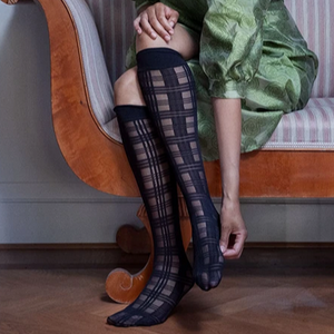 woman wearing black Tartan Knee High