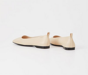 Back view off white flat shoes